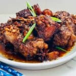 Succulent oxtail pieces simmered in a rich and aromatic sauce, adorned with fragrant green onions and star anise, creating a flavorful and visually appealing dish.