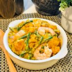 A delectable dish of ginataang sitaw (long beans) and kalabasa (squash) cooked in creamy coconut milk curry sauce with plump shrimp.