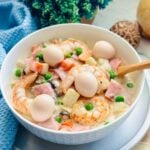 Bowl of sipo egg, a Filipino dish featuring boiled quail eggs, shrimp, and vegetables in a creamy sauce, ready to be served.