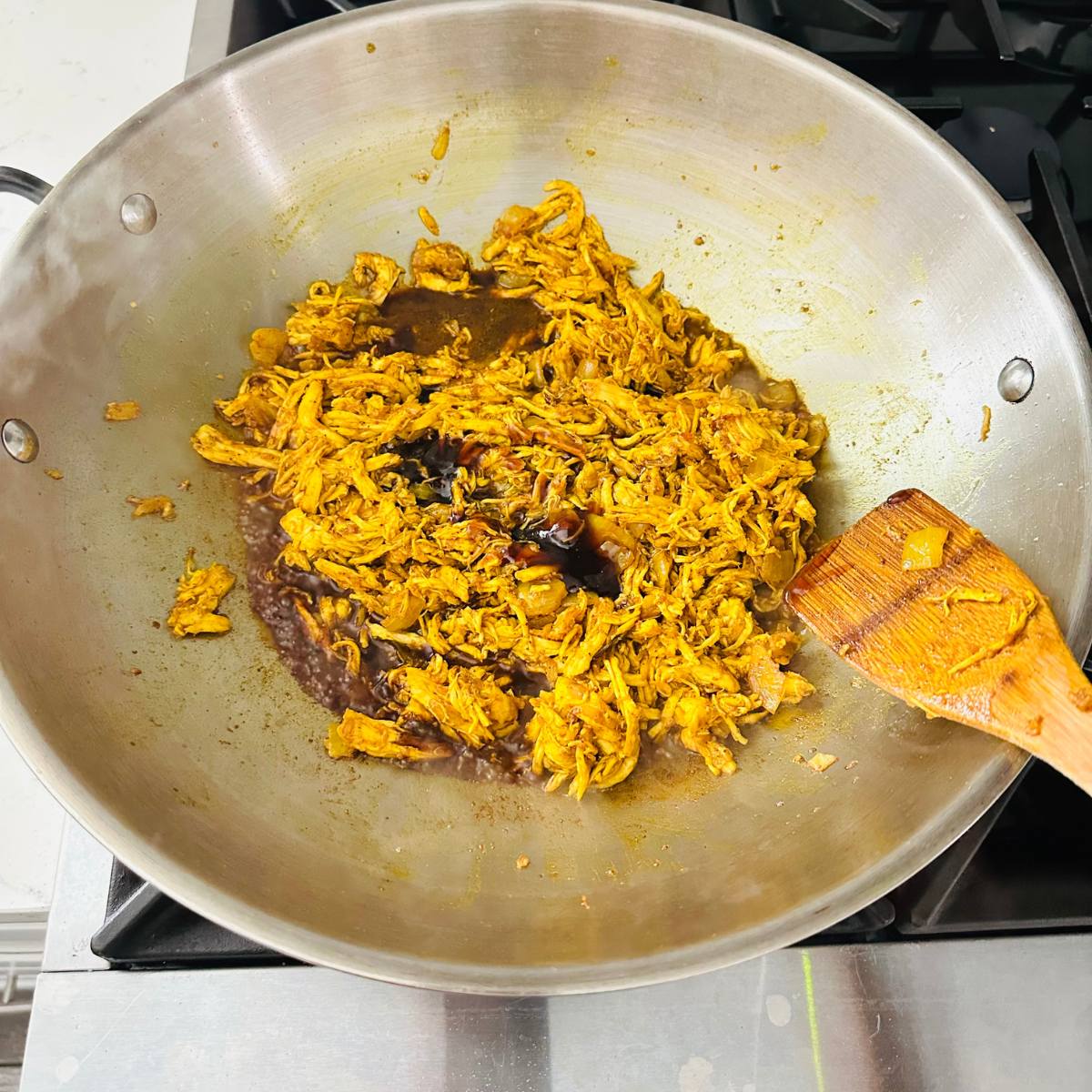 Soy sauce, oyster sauce, sugar, and water added in the pan.