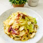 A bowl of Filipino Corned Beef and Cabbage, showcasing tender beef shreds and cabbage.
