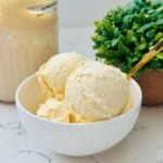A bowl of creamy sweet corn ice cream, showcasing its smooth, yellow texture.