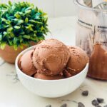 Close-up of scoops of Ninja Creami Chocolate Ice Cream in a bowl. The rich, creamy chocolate ice cream is served in generous, round scoops, showcasing its smooth texture and decadent chocolate flavor.