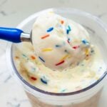 Close-up of Ninja Creami birthday cake ice cream. The ice cream is decorated with colorful sprinkles and cake bits, showcasing a creamy, vanilla base infused with festive birthday cake flavors, ready to be enjoyed.