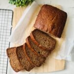 A loaf of moist chocolate banana bread with cottage cheese sliced and ready to eat.