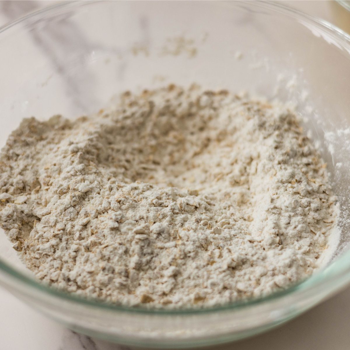 Combining dry ingredients for butter for brown butter oatmeal chocolate chip cookies.