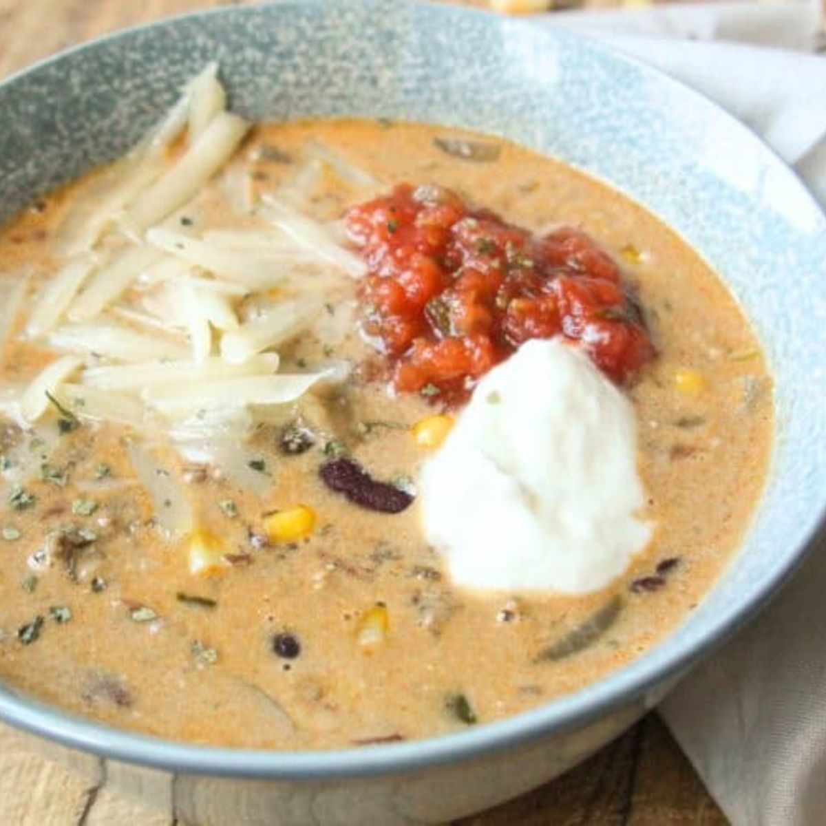 Bowl of Creamy Taco Soup with beef, beans, corn, and cheese โ comforting one-pot fall dinner