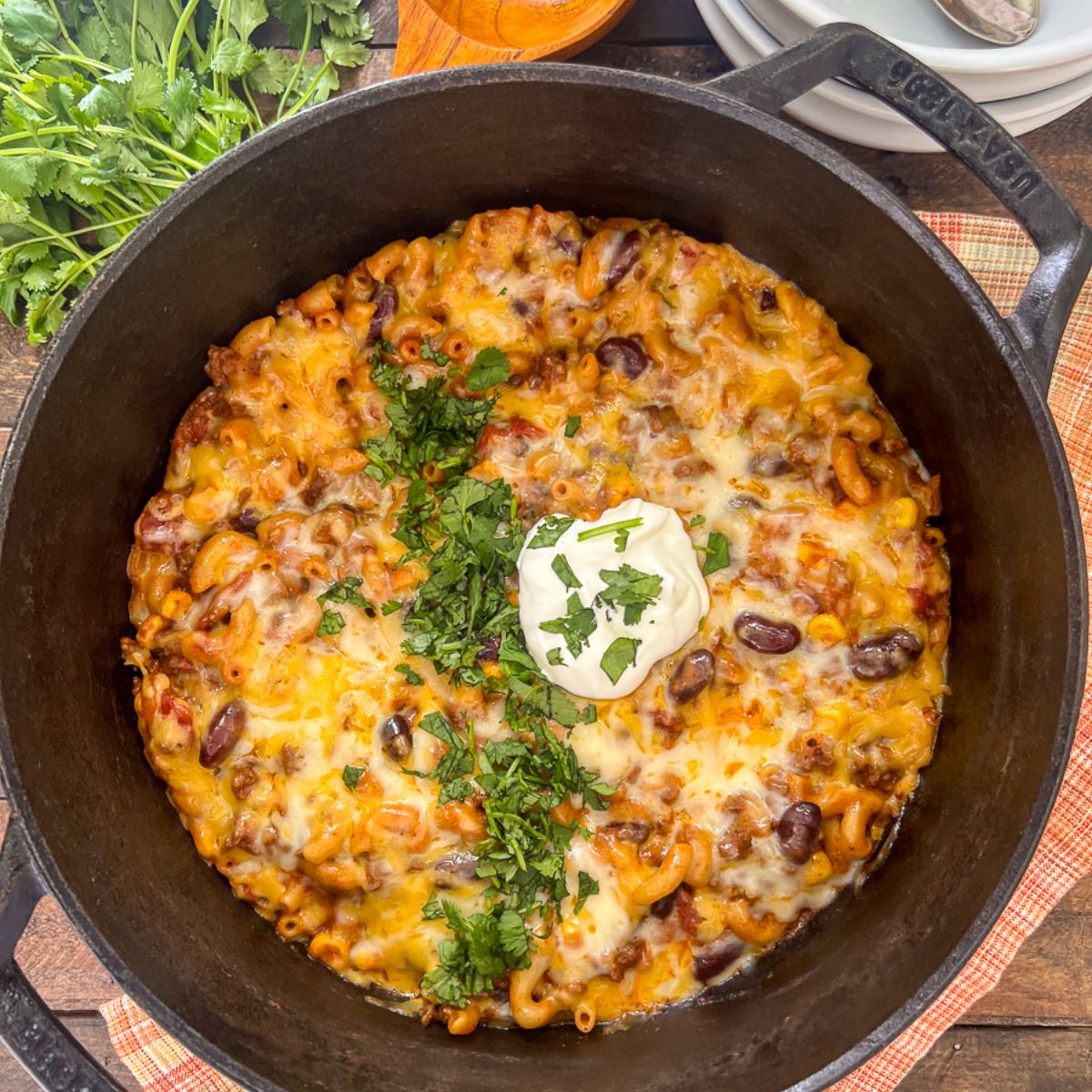 Dutch Oven Chili Mac topped with melted cheese โ hearty one-pot beef and pasta dinner.