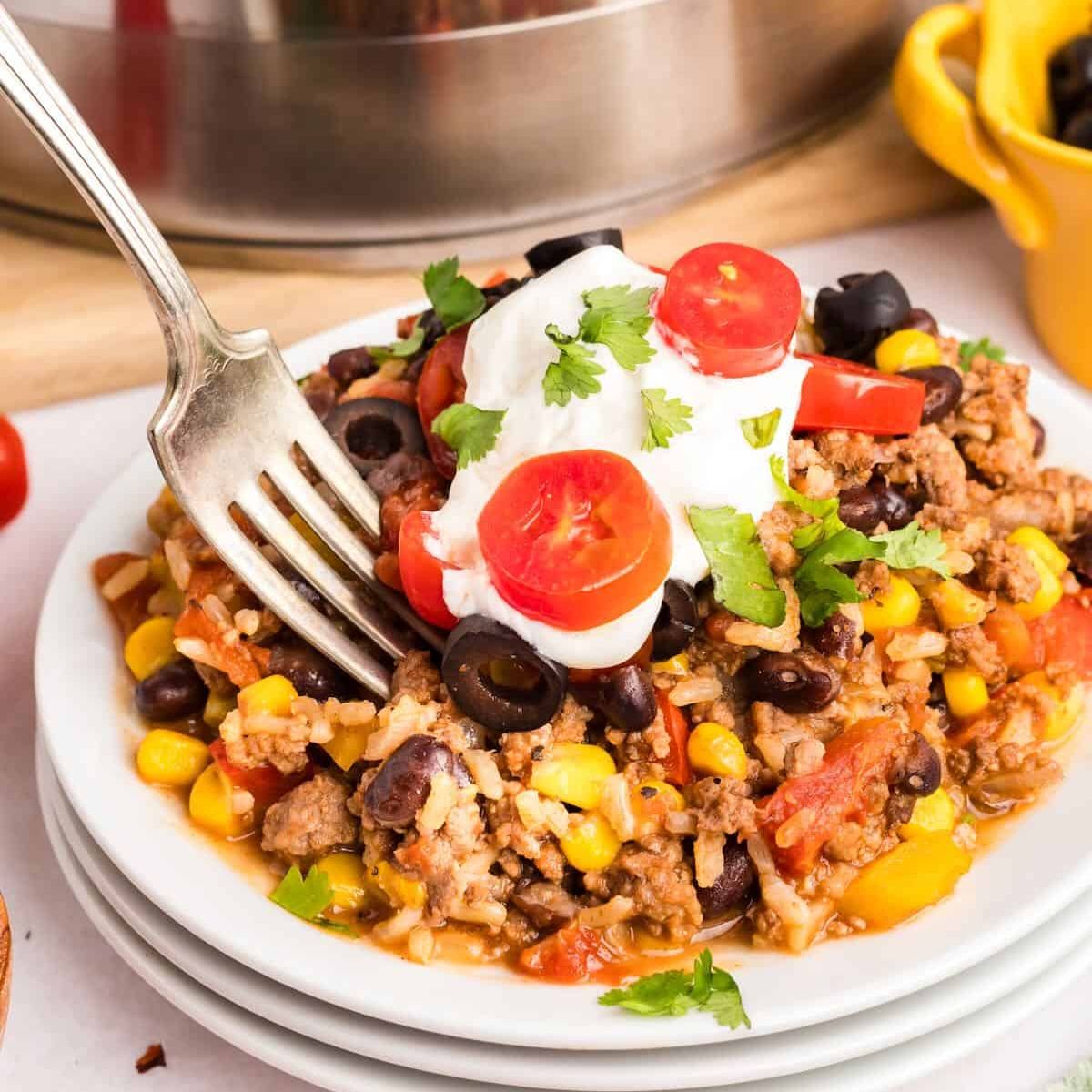 One-pan Mexican Beef Rice Skillet with melty cheese, seasoned ground beef, and rice โ easy 30-minute Tex-Mex dinner.