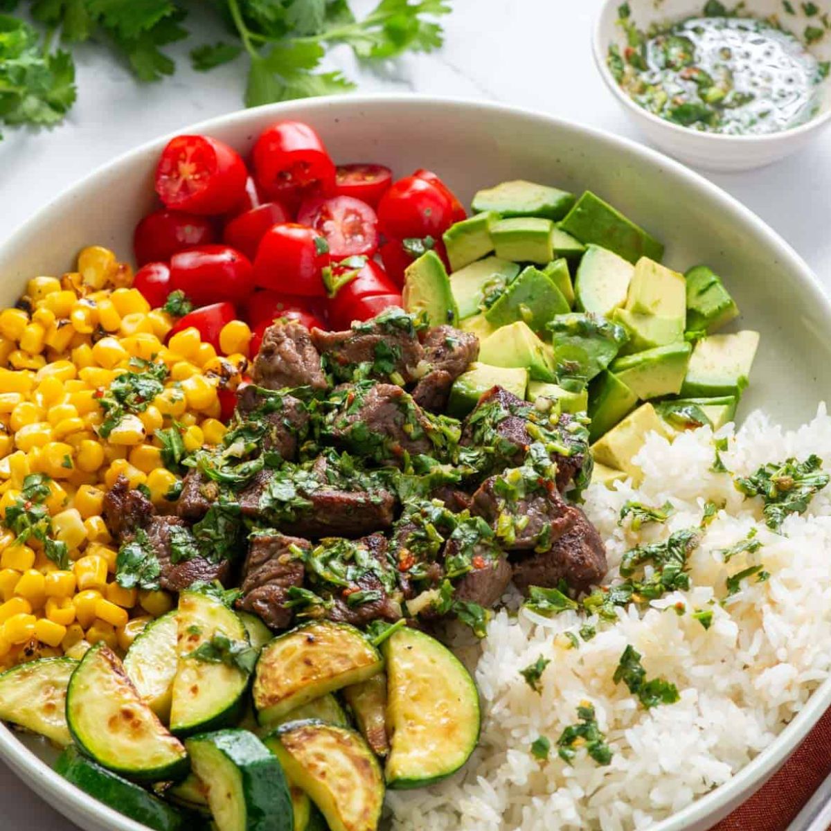Southwestern Steak and Rice Bowl drizzled with cilantro chimichurri โ fresh, colorful, high-protein beef dinner.