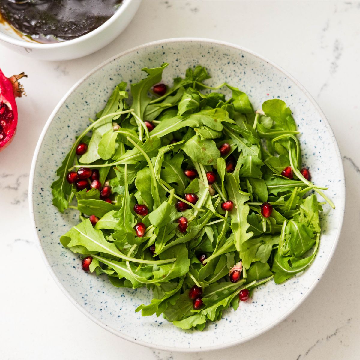 Holiday arugula salad with pomegranate, easy five-minute salad recipe.