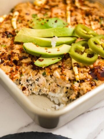 Pan of spicy tuna sushi bake made with rice, furikake, and baked tuna mixture, ready to serve.
