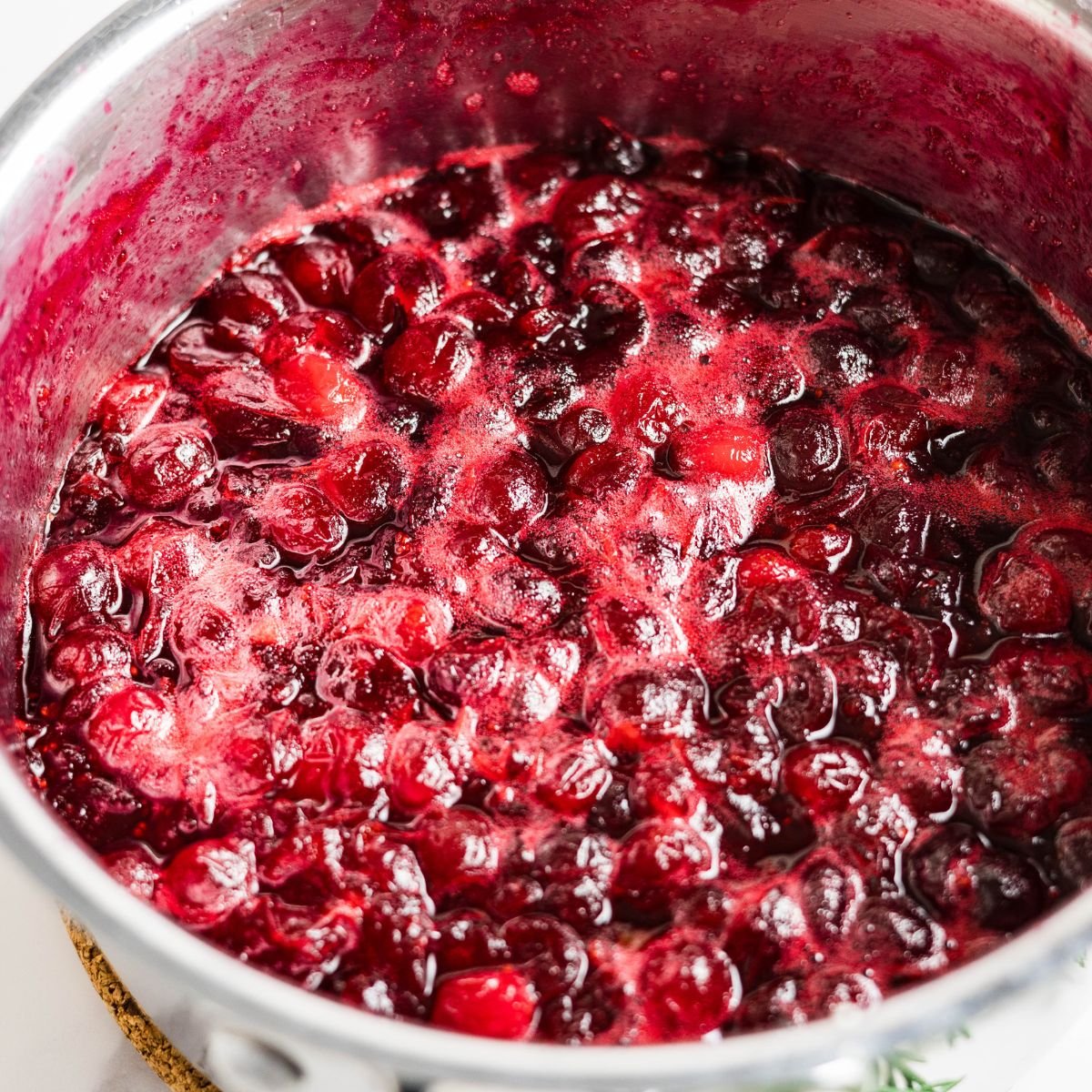 Simmering cranberry sauce made with allulose instead of sugar.