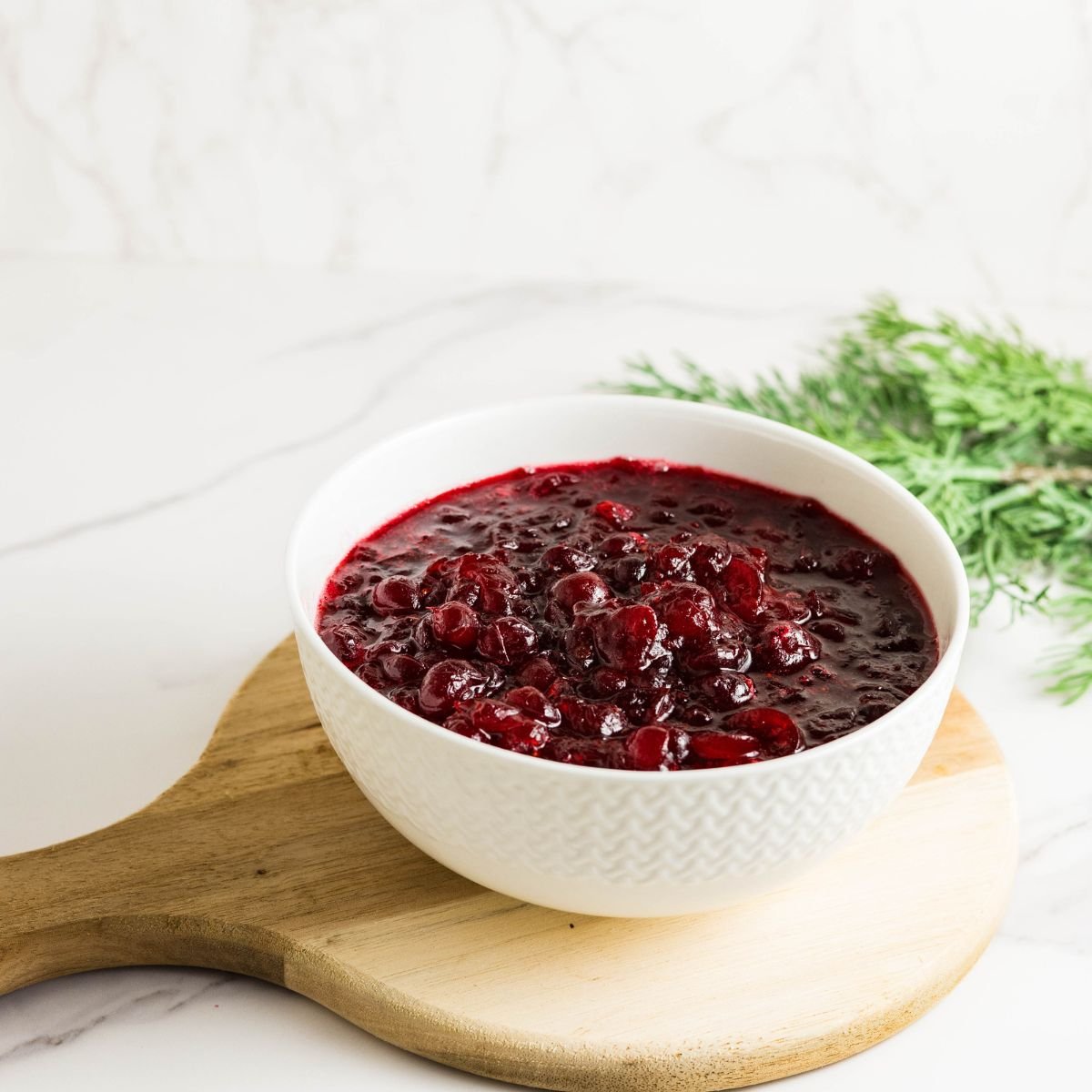 Sugar free cranberry sauce made with fresh cranberries and allulose in a bowl.