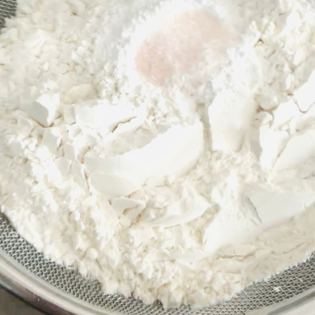 Whisking flour, baking powder, and salt together in a small bowl for ube cookies.