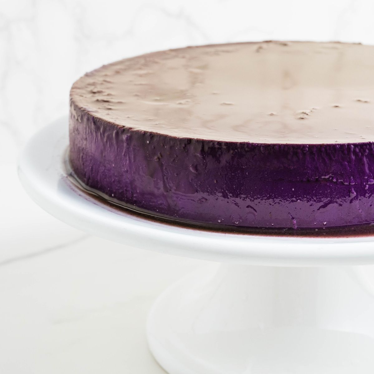 Ube leche flan highlighting its smooth, creamy purple custard and glossy finish.