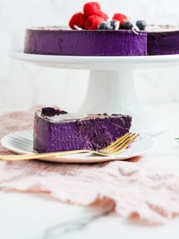 Slice of ube leche flan on a plate, showing its vibrant purple color and creamy, silky custard texture.
