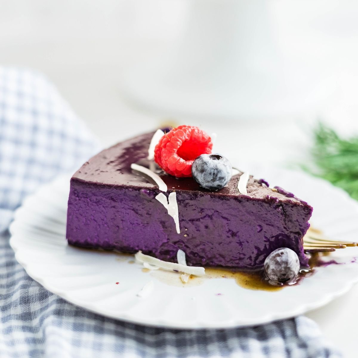Slice of ube leche flan on a plate, showing its vibrant purple color and creamy, silky custard texture.