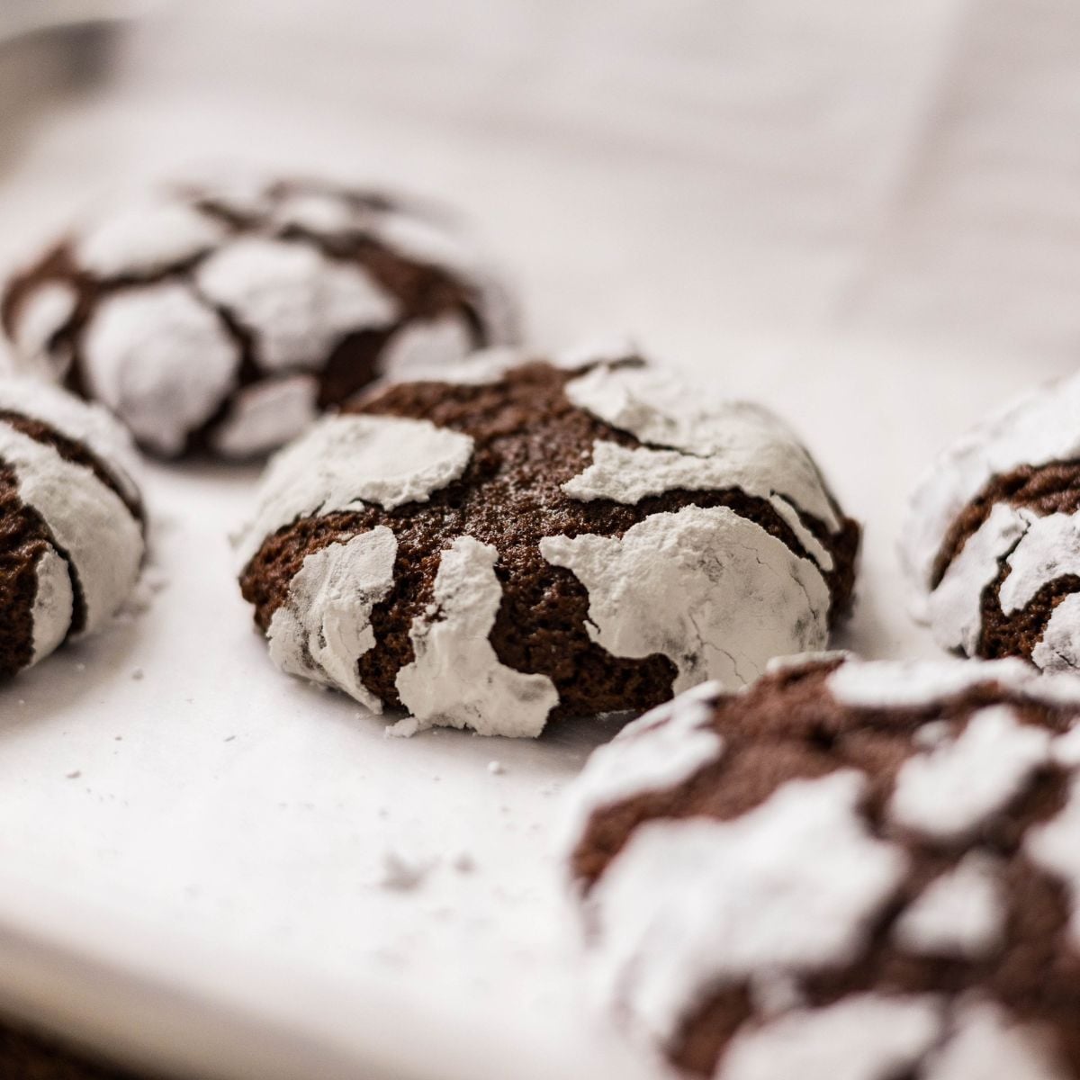 Baking tray filled with freshly baked chocolate crinkle cookies.