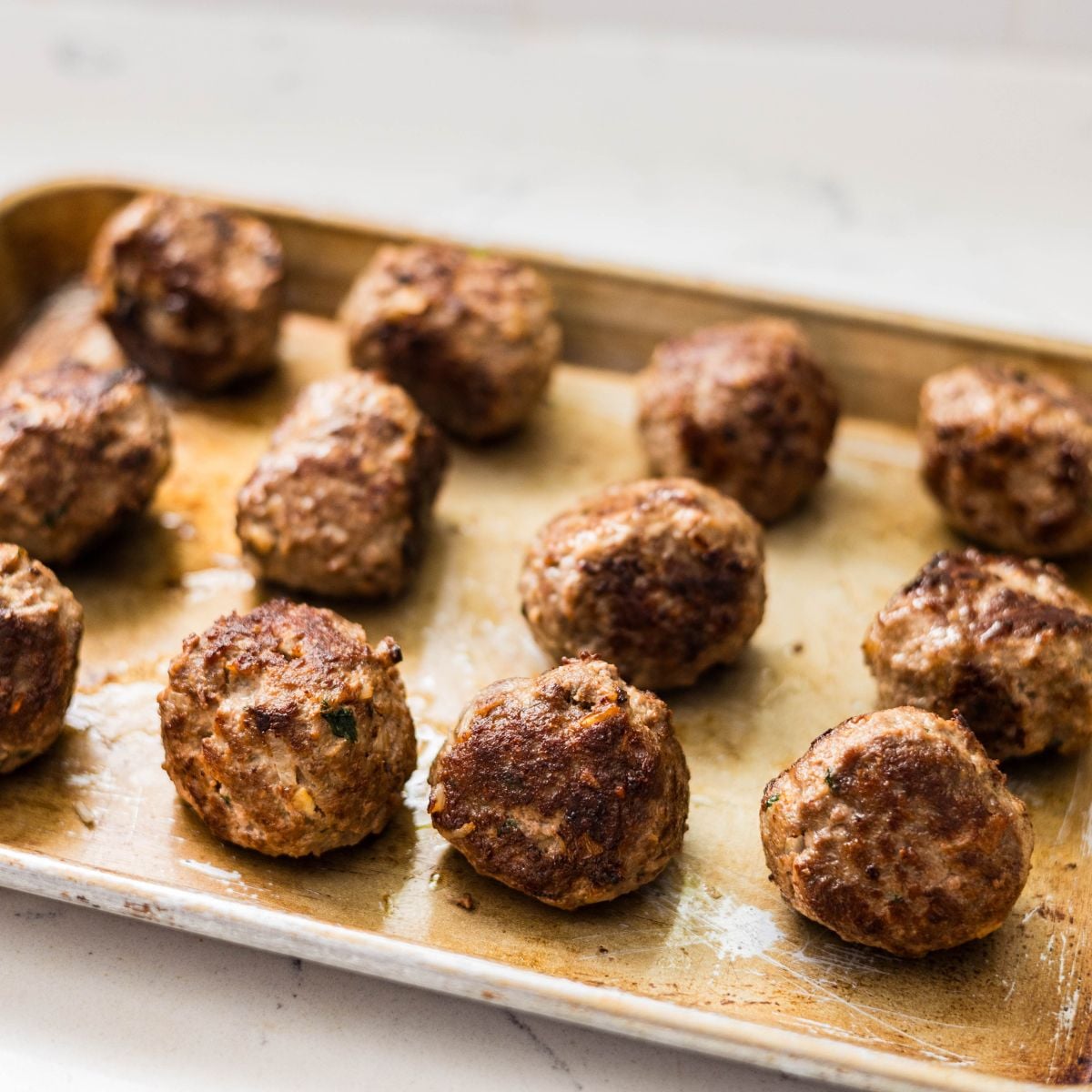 Browned meatballs ready for baking.