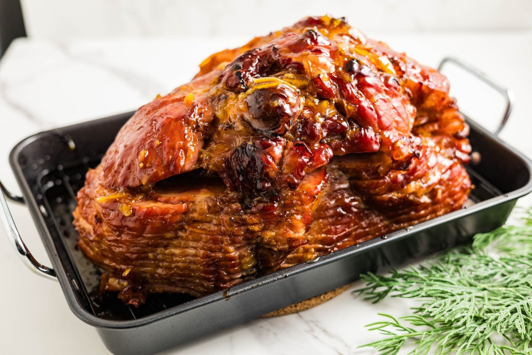 Spiral ham baked with orange marmalade and maple syrup glaze, caramelized edges and shiny finish.