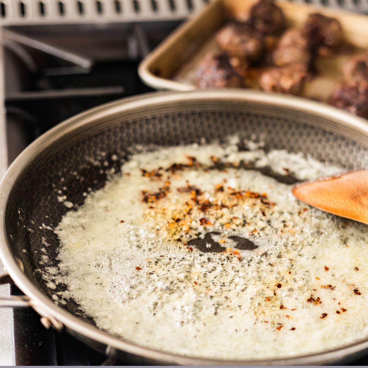 Sauteed garlic and crushed chili in butter .