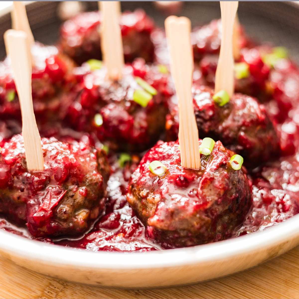 Easy cranberry sauce meatballs on a skillet. 