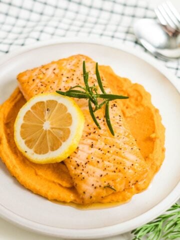 Pan-seared salmon with garlic, rosemary and lemon ready to be served.