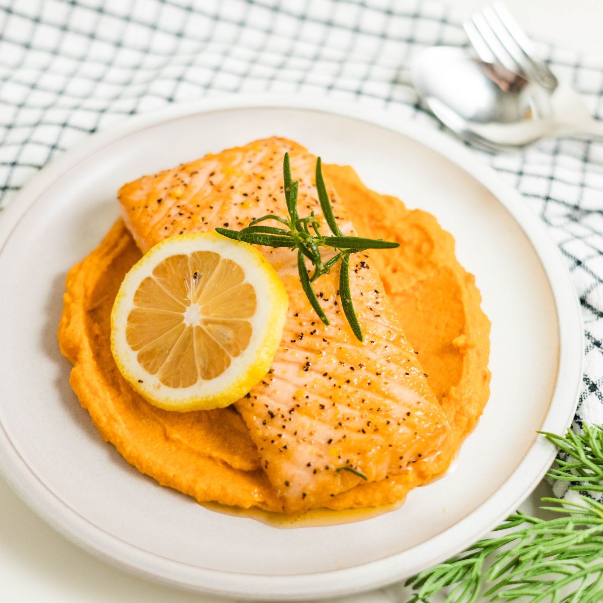 Pan-seared salmon with garlic, rosemary and lemon ready to be served.