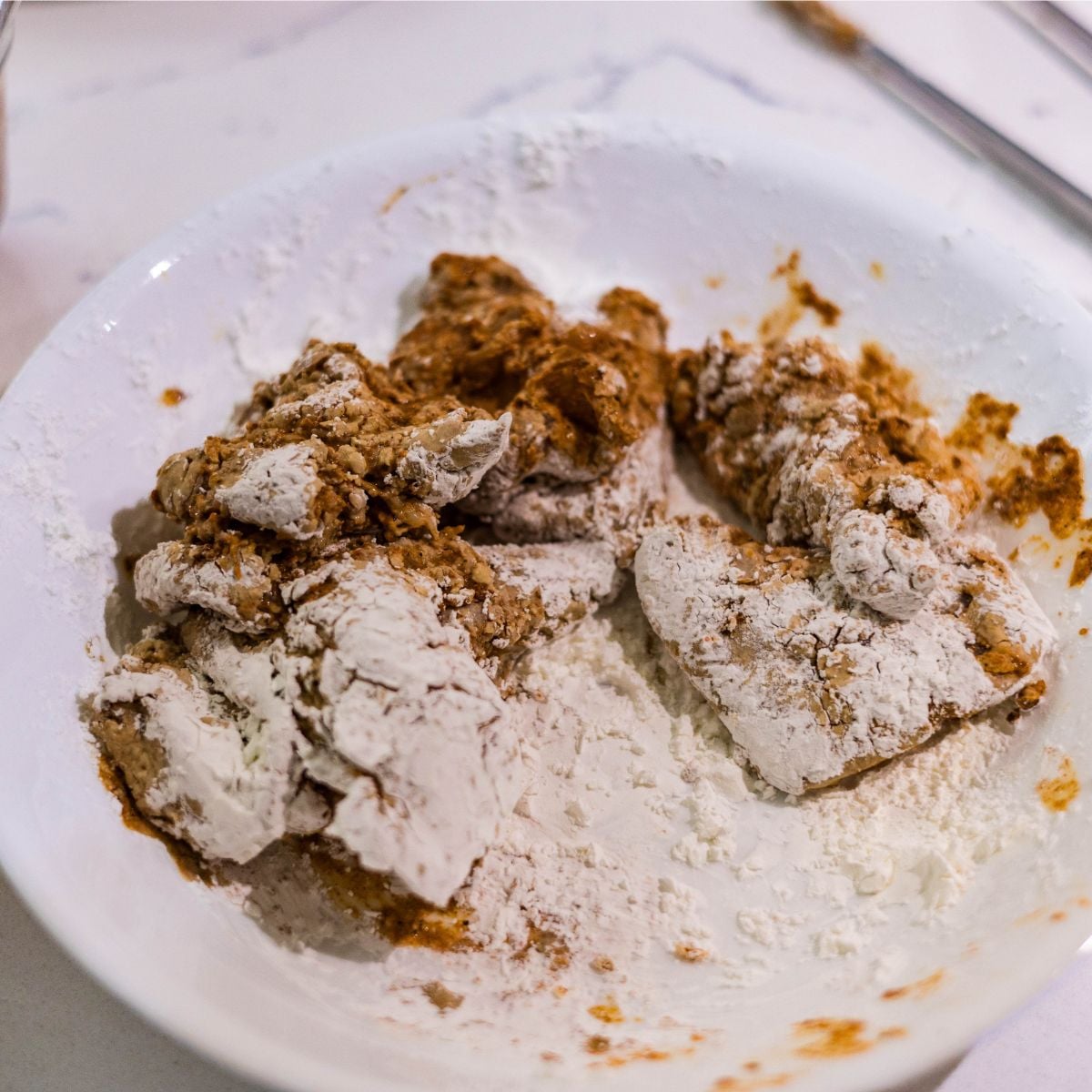 Marinated chicken pieces coated in cornstarch for crispy Chicken 65