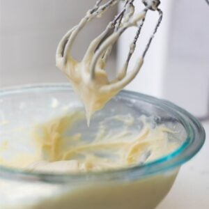 Cream cheese frosting texture for cinnamon rolls showing soft peaks on mixer beaters