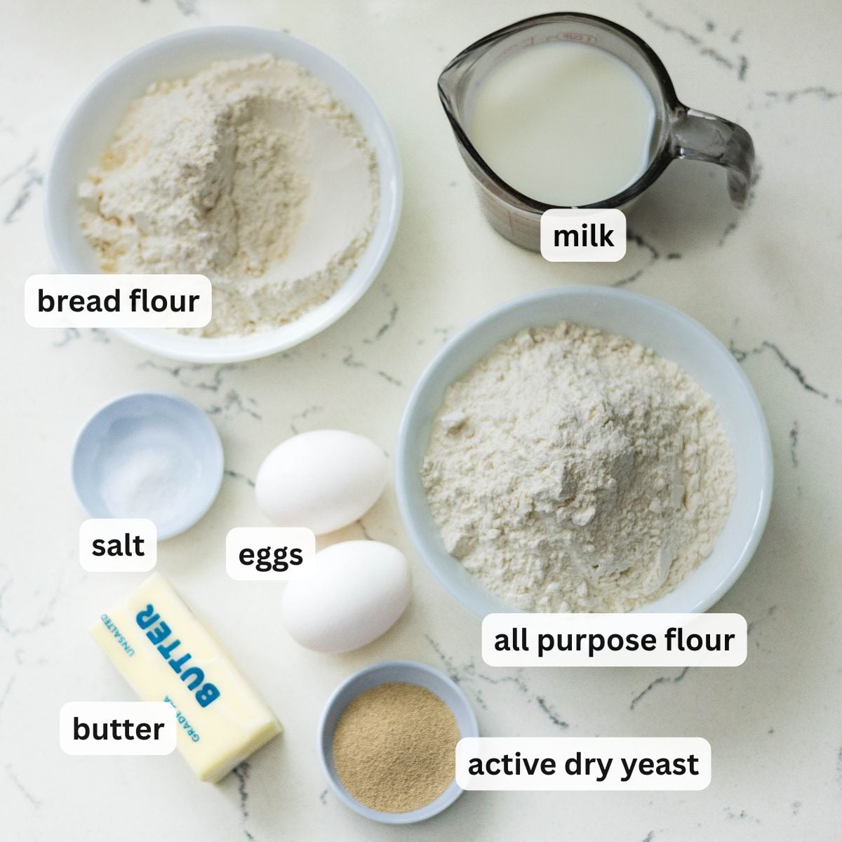Filipino ensaymada ingredients including bread flour all purpose flour milk eggs butter yeast and salt