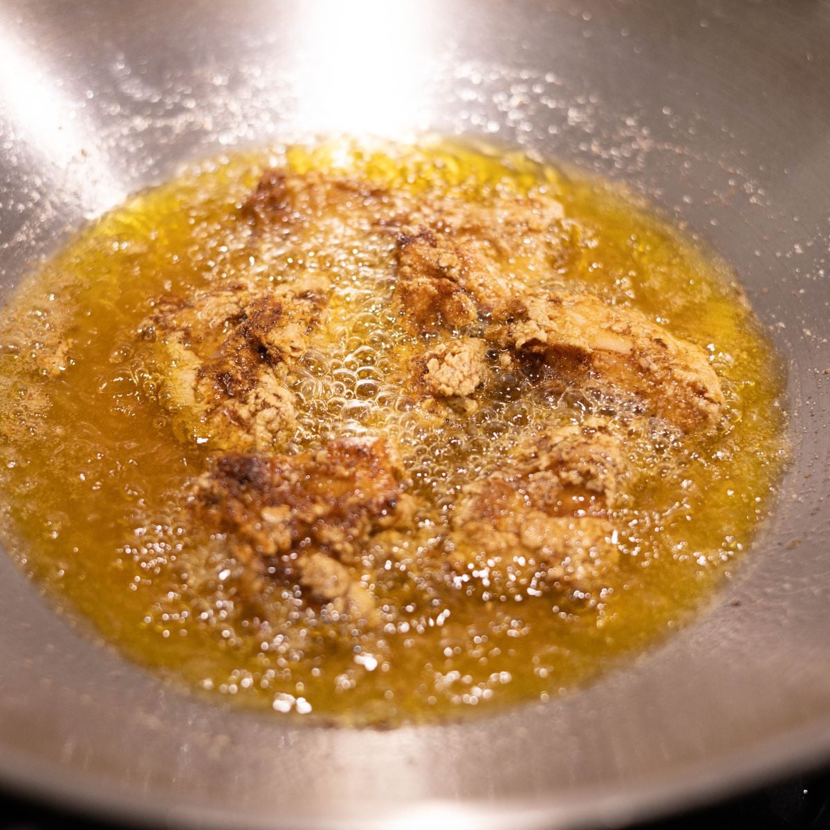 Chicken 65 frying in hot oil until golden and crispy