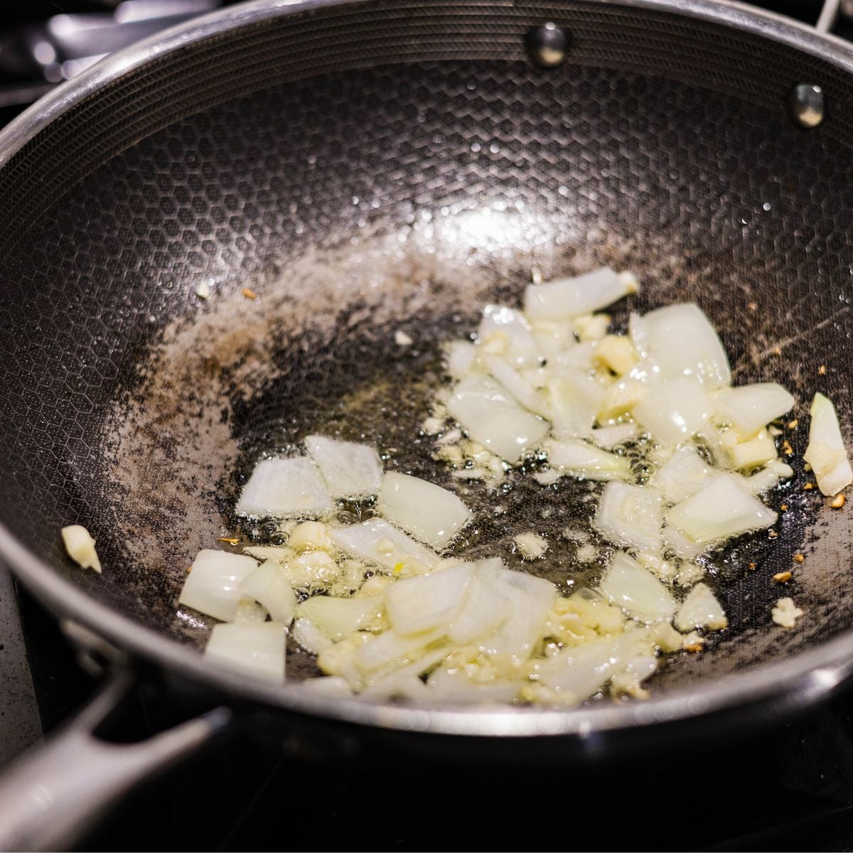 Garlic and onion sautéing in oil as the base for ginisang sayote.