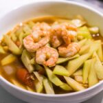 Bowl of ginisang sayote with shrimp served hot in a light savory tomato broth.