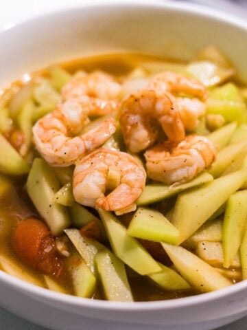 Bowl of ginisang sayote with shrimp served hot in a light savory tomato broth.