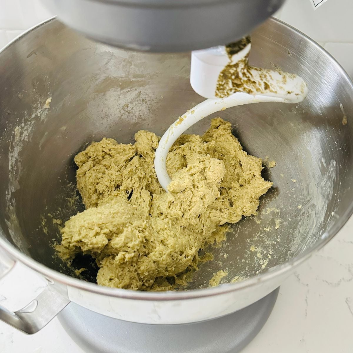 Malunggay pandesal dough mixing in a stand mixer bowl.