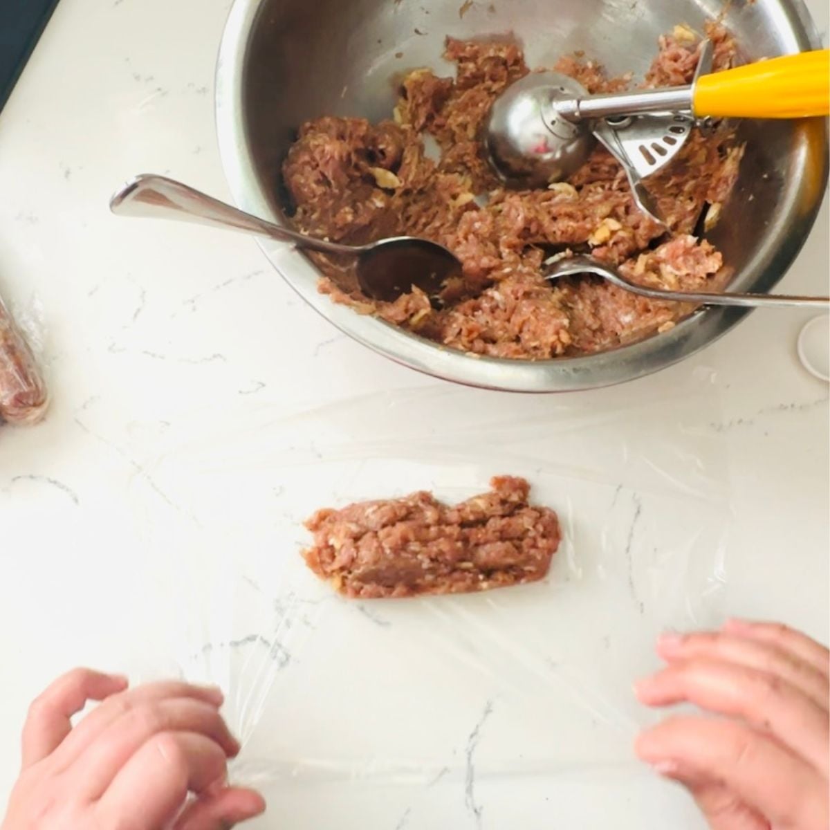 Wrapping vigan longanisa in a cling wrap