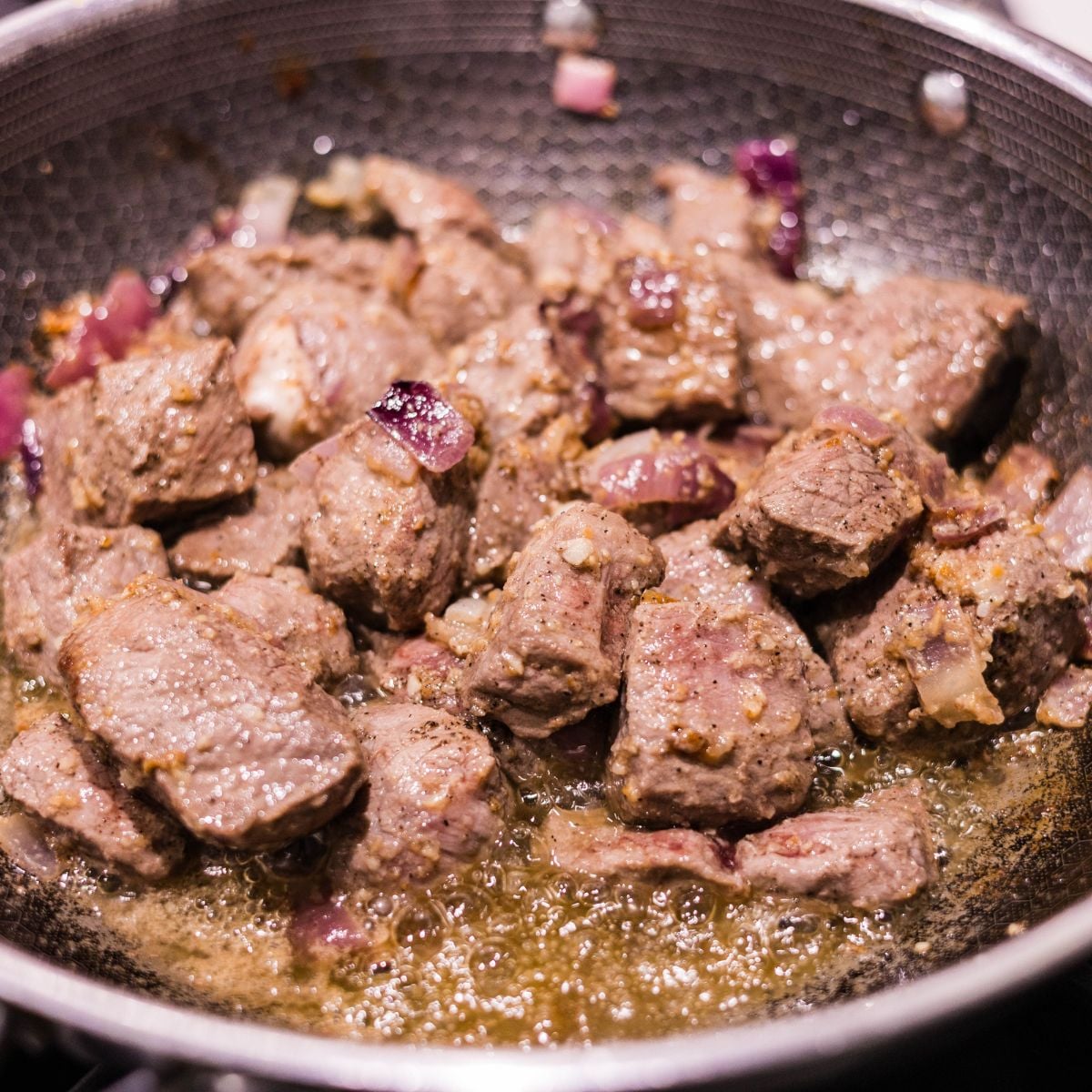 Beef chunks sautéed with onions and garlic for Beef Caldereta with Cheese