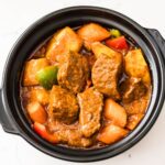 Filipino Beef Caldereta with Cheese served with potatoes, carrots, and bell peppers