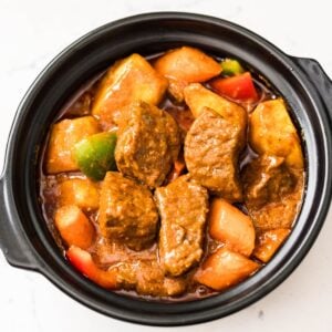 Filipino Beef Caldereta with Cheese served with potatoes, carrots, and bell peppers