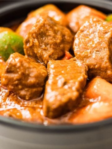 Filipino Beef Caldereta with Cheese served with potatoes, carrots, and bell peppers