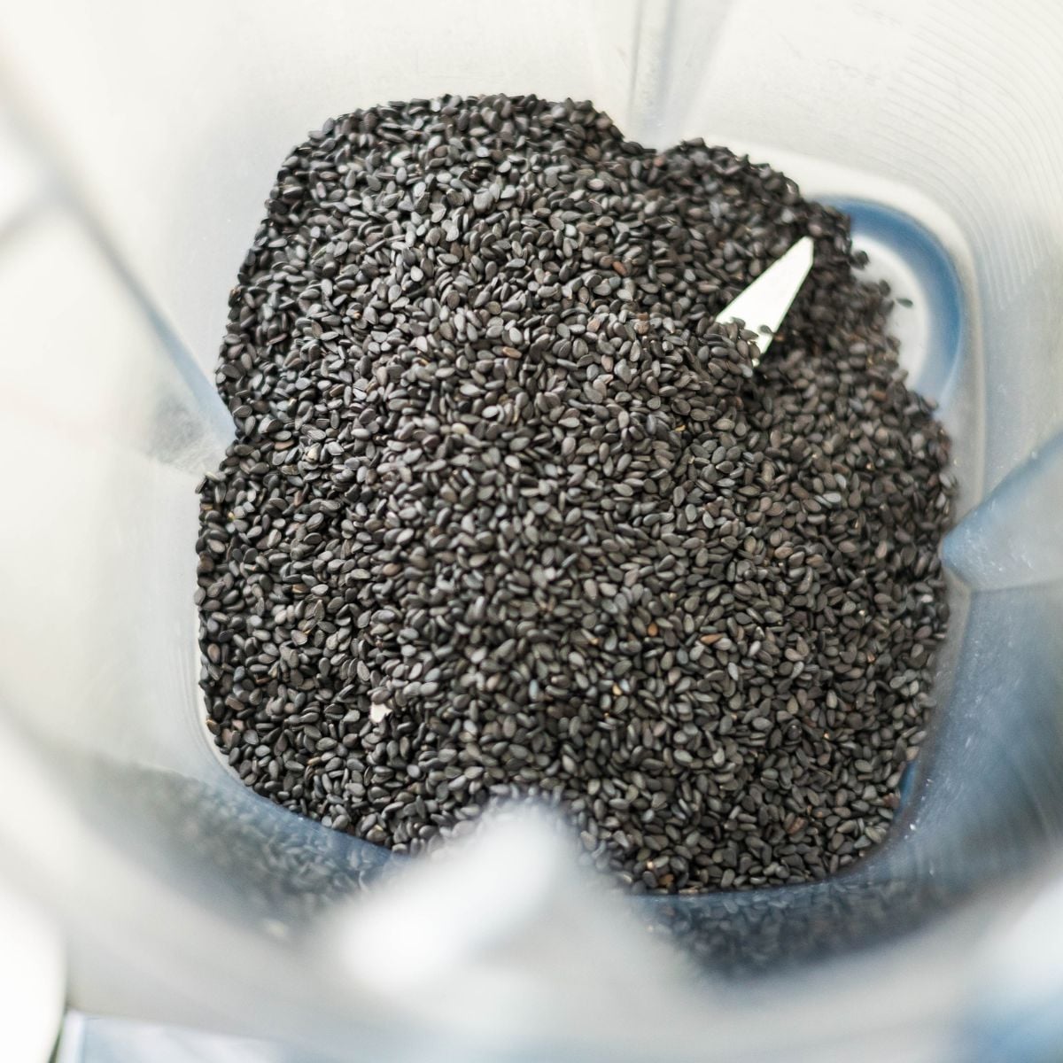 Black sesame seeds being ground in a Vitamix blender.