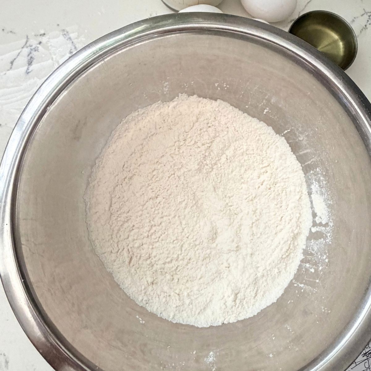 all purpose flour on a stainless steel bowl.