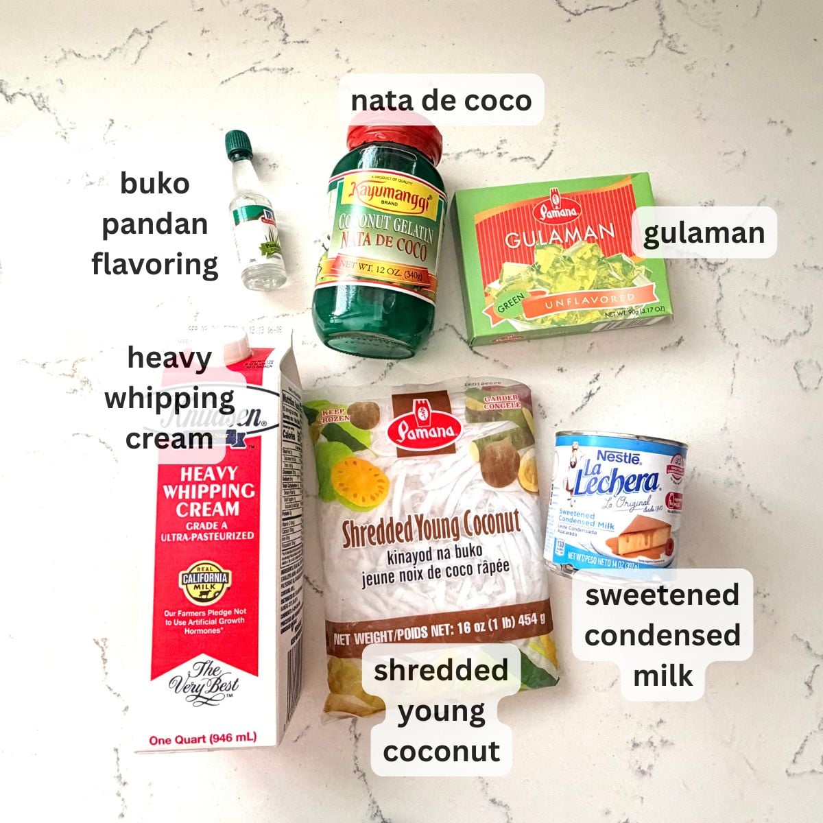 Ingredients for buko pandan salad including coconut, pandan jelly, cream, and condensed milk