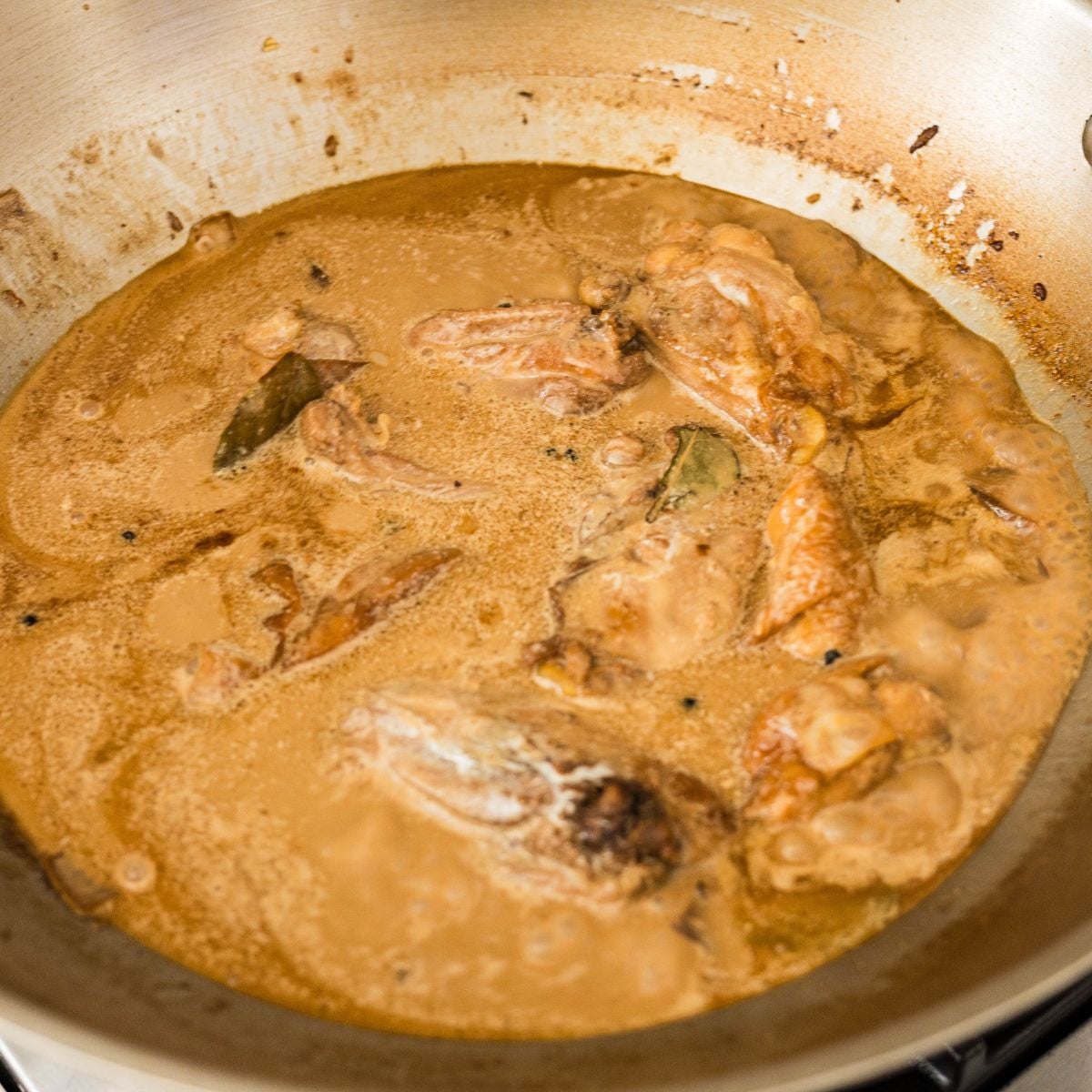 Coconut milk added to chicken adobo, turning the sauce creamy
