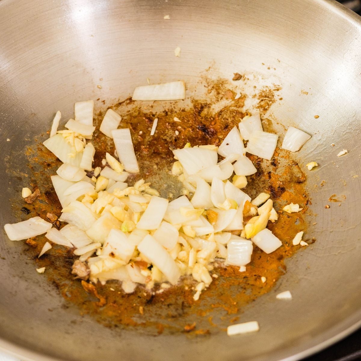 Chopped garlic and onion sautéing in oil in a pan