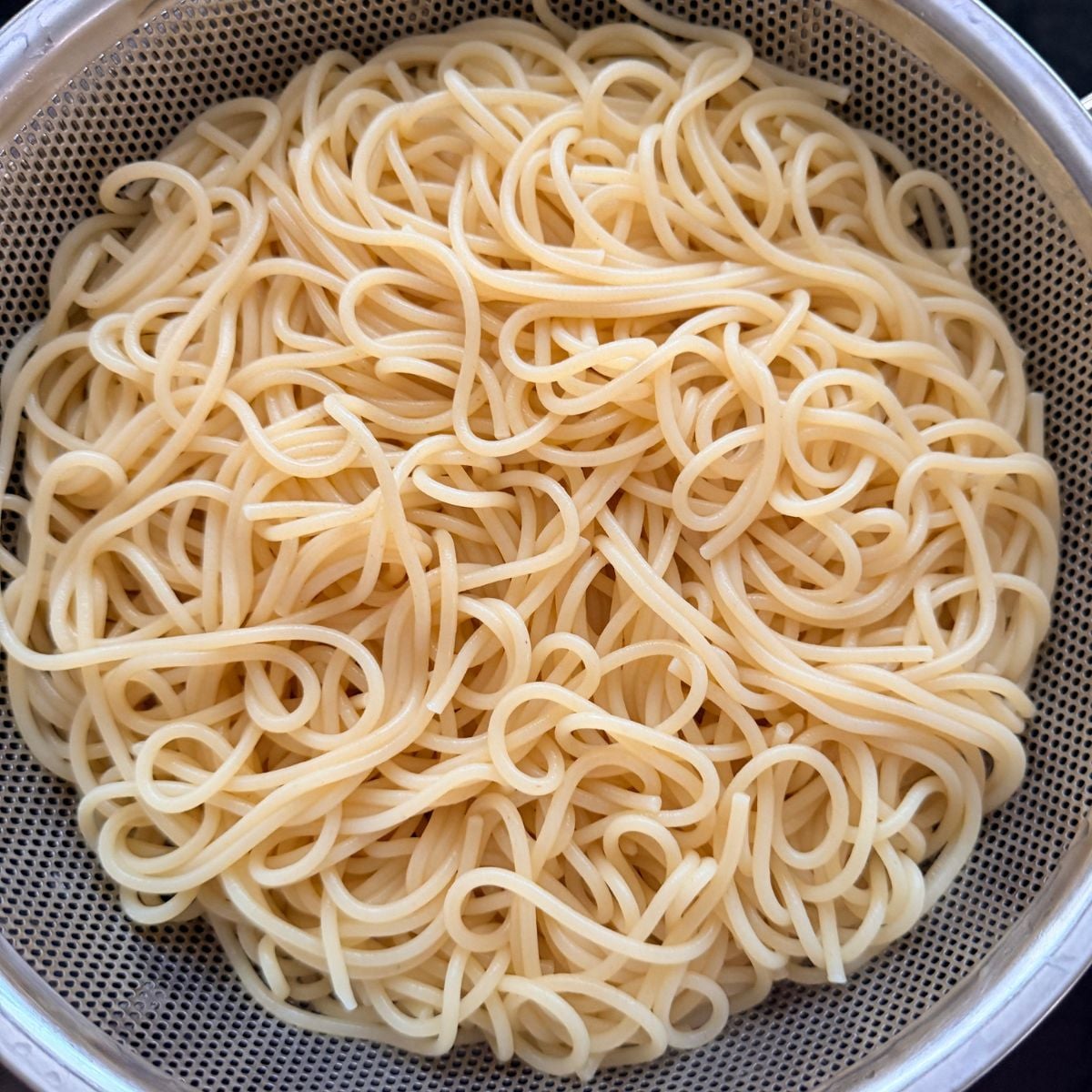 Cooked spaghetti noodles drained and ready for Filipino spaghetti