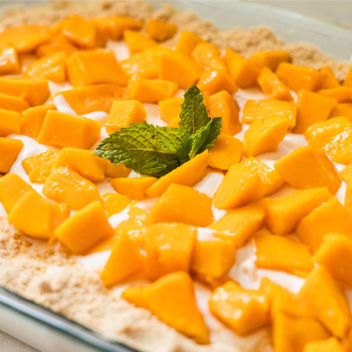 Easy Filipino mango float topped with diced mangoes and mint