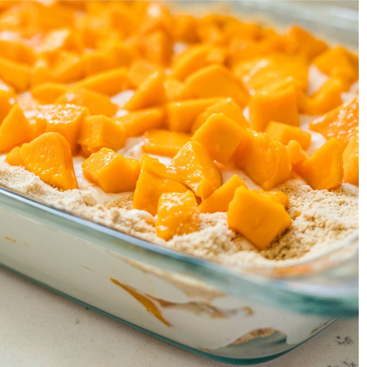 Filipino mango float topped with fresh diced mangoes